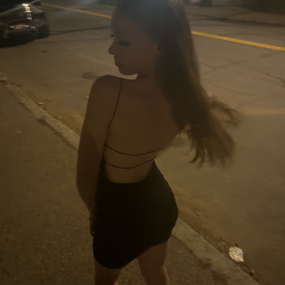 Black dress with open back and scrunched bottom.